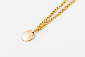 Picture of the mizza necklace, a Nelumbo jewelry piece, handmade from 14k solid gold