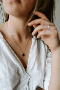 Picture of the Chella necklace, a Nelumbo jewelry piece, handmade from 925 sterling silver and onyx stone