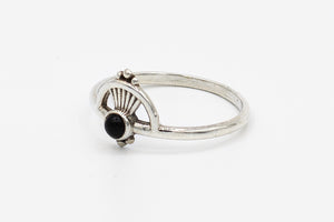 Picture of the Kaia ring, a Nelumbo jewelry piece, handmade from 925 sterling silver and onyx stone